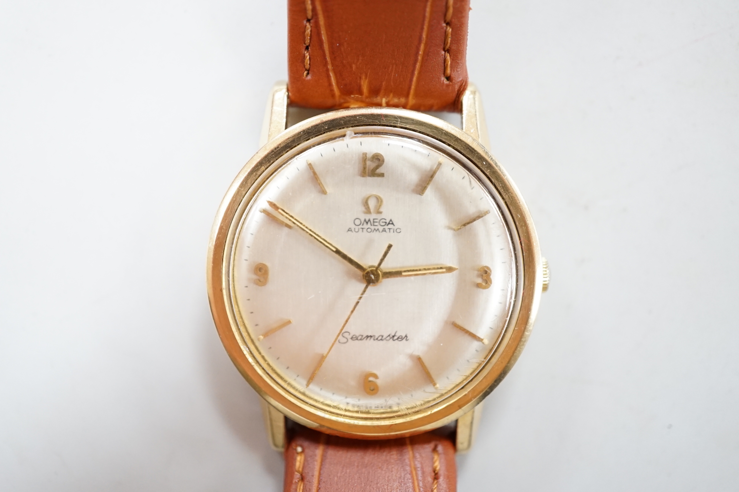 A gentleman's mid 1960's 9ct gold Omega Seamaster automatic wrist watch, movement c.552 on later associated strap, case diameter 35mm, with Omega box.